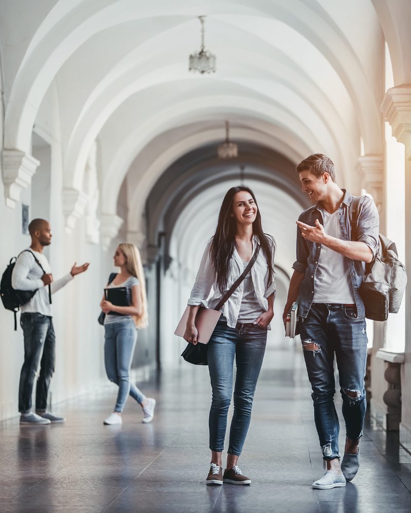 Students in school uniforms working together on a collaborative leadership task.